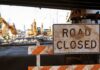 Bulldozers Roll — Cartel Crossings Spur Quiet Buildout Road closed sign at construction site under overpass