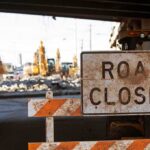 Road closed sign at construction site under overpass