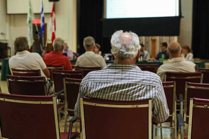 Audience members seated facing a presentation screen