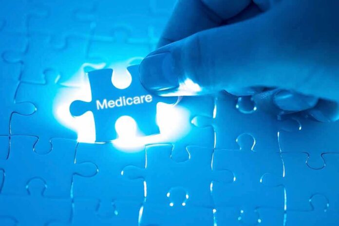 shutterstock_1018157575 Hand placing a puzzle piece labeled Medicare