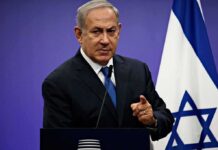 Moral Cowards: Netanyahu Torches UN man in suit speaking at a podium with an Israeli flag