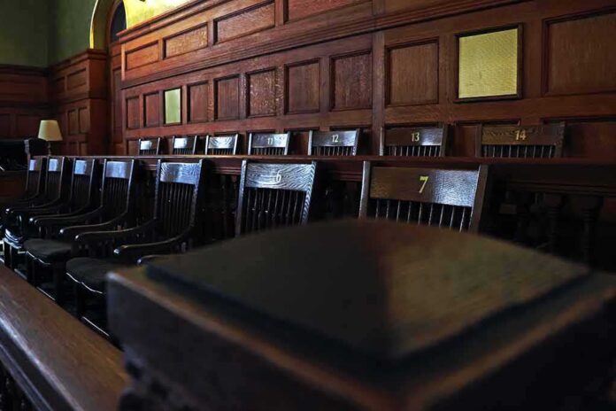 shutterstock_1132288550-1 Empty wooden jury box with numbered chairs