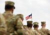 Contempt Charge Hits Active-Duty Officer U.S. flag flying above a formation of soldiers in uniform