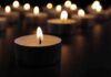 Tealight candle burning with soft glow