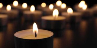 Tealight candle burning with soft glow