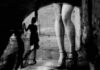 Moral Policing? Biometrics Target Adult Creators legs in high heels under an archway with blurred shadow figure