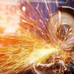 Angle grinder cutting metal with bright sparks