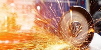 Angle grinder cutting metal with bright sparks