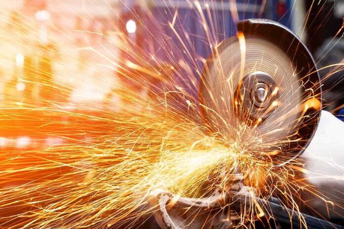 shutterstock_1300144306-2 Angle grinder cutting metal with bright sparks