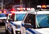 police cars with flashing lights on a city street