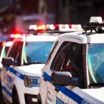 police cars with flashing lights on a city street