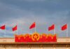 Beijing’s ‘Peace’ Masks A War Play Chinese flags atop a decorated building facade
