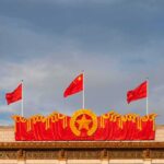 Beijing’s ‘Peace’ Masks A War Play Chinese flags atop a decorated building facade
