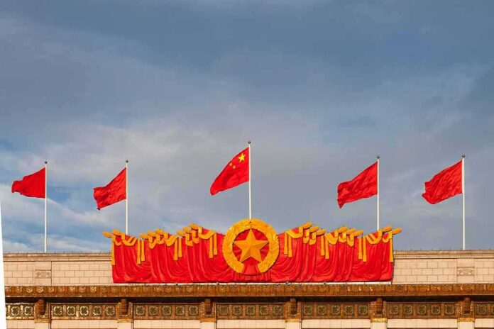 shutterstock_1466806730 Chinese flags atop a decorated building facade