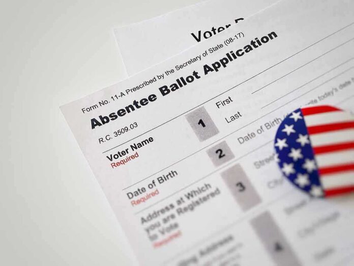 shutterstock_1562688913 Absentee ballot application with patriotic button
