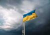 Patriot Drought Puts Kyiv In The Crosshairs Ukrainian flag waving against a stormy sky