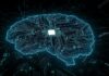 Trump Team Greenlights AI – With Handcuffs Digital brain shaped circuit board with central microchip