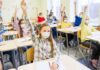 City Orders Attendance Enforcers In Every School students wearing masks raise hands in a classroom