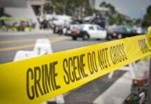 Family Massacre Sparks Deadly Interstate Pursuit crime scene tape stretches across a blocked city street