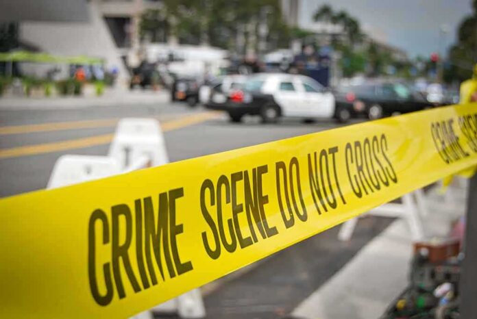 shutterstock_1935517810 crime scene tape stretches across a blocked city street