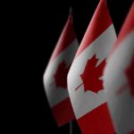 Canada’s Wild EU Upgrade – Backroom Bloc Freezes Out U.S. Canadian flags with maple leaf on dark background