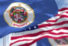 Feeding Our Future Fallout Engulfs Flanagan Minnesota state flag waving in the wind