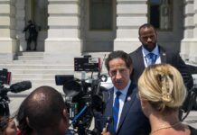 NBC Bombshell Meets Raskin’s Reality Bend Man in suit speaks to reporters outside a government building