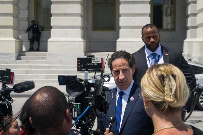 shutterstock_2177969953 Man in suit speaks to reporters outside a government building