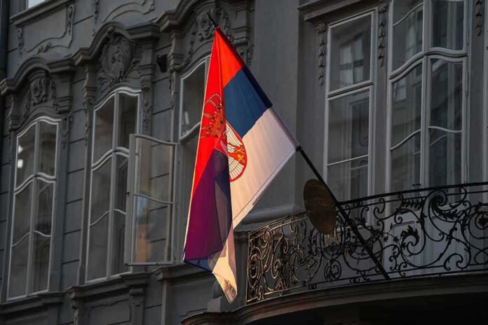 shutterstock_2211445067 Serbian flag on a building facade