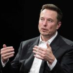 Musk Slams ‘Shallow Empathy’—Victims First man in a suit speaking with hand gestures