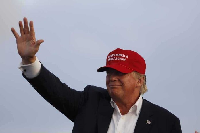 September,15,,2015,,Donald,Trump,,2016,Republican,Presidential,Candidate,,Speaks Donald Trump waving in a red cap