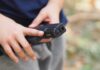 hands holding a black handgun