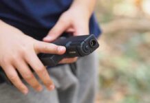 Gun Control Twist: BBs Treated Like Firearms? hands holding a black handgun