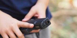 hands holding a black handgun