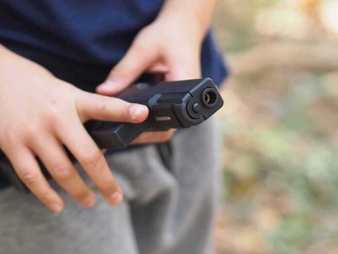 hands holding a black handgun