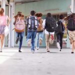 DOJ Crackdown Halts Kids’ Gender Drugs group of schoolchildren running with backpacks