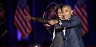Michelle Obama and Rob Nabors pointing on stage at an event
