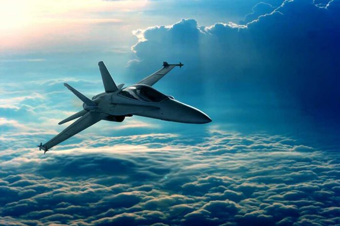 View,Of,A,Fighter,Jet,Above,The,Clouds A fighter jet flying above the clouds during sunset