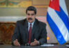 Nicolás Maduro speaking at a podium with a microphone