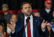 Vance Quip Detonates Texas Senate Brawl Man in suit speaking at a podium