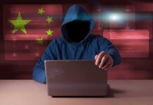 WeChat Clues Expose Covert Mission Hooded figure using a laptop with red cybersecurity graphics