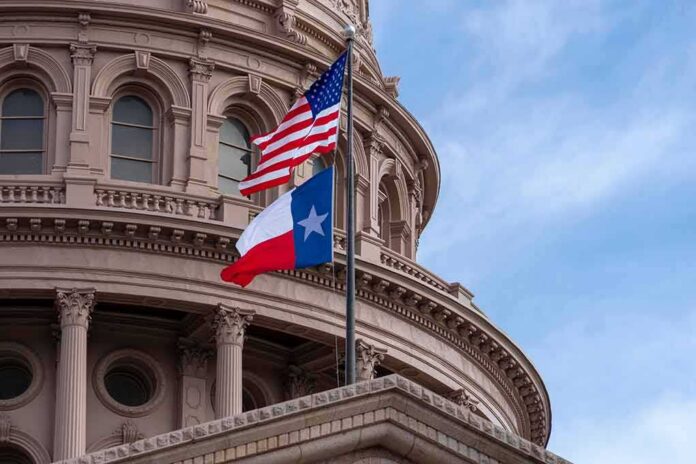 shutterstock_1216088524-2 Texas and U.S. flags in front of a capitol building dome