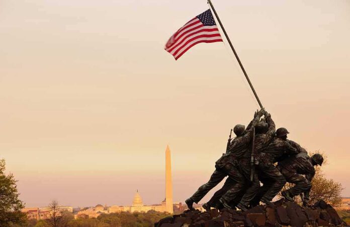Iwo Jima Memorial with soldiers raising the American flag at sunset