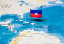 Armored Convoy Torched Near Port-au-Prince – Four Missing Haiti flag pin on a map of the Caribbean