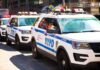 Hate-Crime Stabbing Rattles Midtown NYPD police SUVs parked in a row on a city street