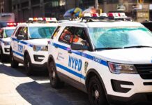 Hate-Crime Stabbing Rattles Midtown NYPD police SUVs parked in a row on a city street