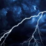 Four Dead – Power Grid Crumples As Isaias Strikes Lightning bolts streak across dark storm clouds