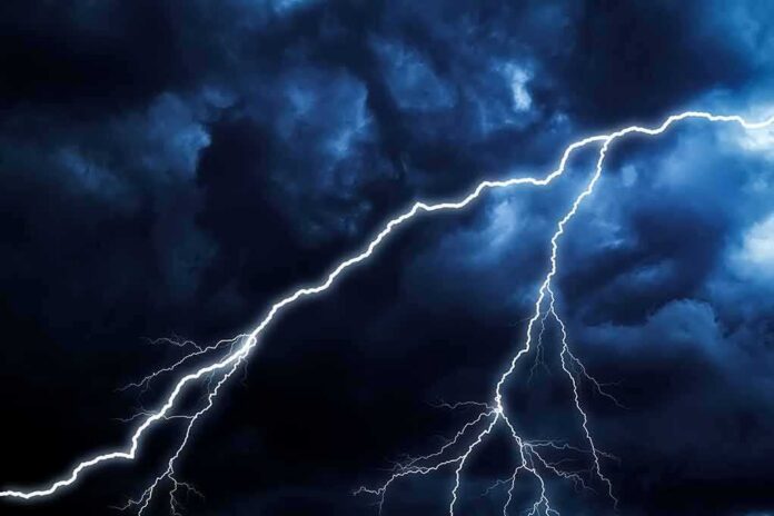 Lightning bolts streak across dark storm clouds