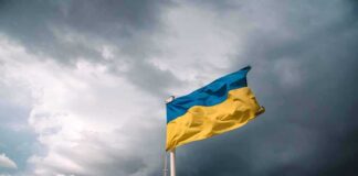 Ukrainian flag waving against a stormy sky
