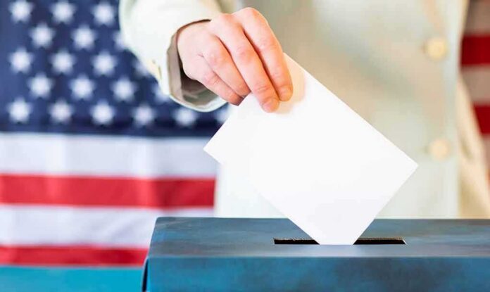 Hand placing ballot into a box